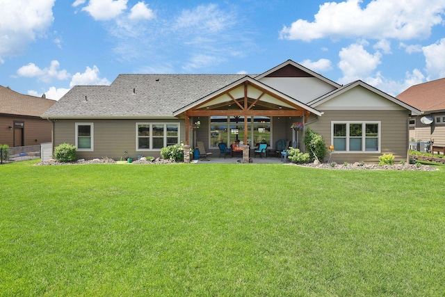 1002 N High Desert Dr, Deer Park, WA 99006 - rear view of house featuring a patio area, a yard, and a shingled roof