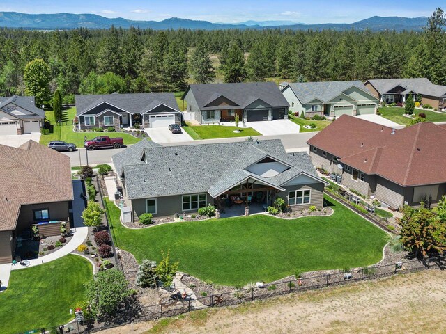 1002 N High Desert Dr, Deer Park, WA 99006 - aerial perspective of suburban area with a heavily wooded area and mountains