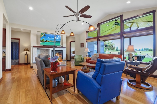 1002 N High Desert Dr, Deer Park, WA 99006 - living room featuring a glass covered fireplace, ceiling fan, light wood-type flooring, recessed lighting, and high vaulted ceiling
