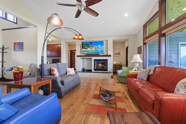 1002 N High Desert Dr, Deer Park, WA 99006 - living area with vaulted ceiling, light wood-style flooring, a ceiling fan, a lit fireplace, and recessed lighting