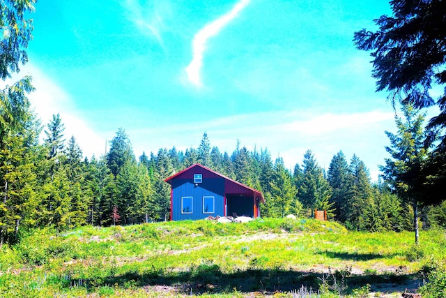 1261 Outback Ln, Usk, WA 99180 - view of yard featuring an outbuilding, an outdoor structure, and a wooded view