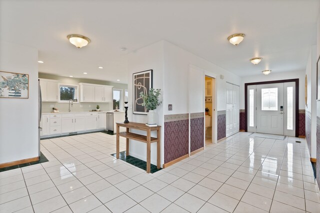 609 E Wild Rose Rd, Colbert, WA 99005 - entrance foyer featuring light tile patterned flooring, healthy amount of natural light, wainscoting, and baseboards