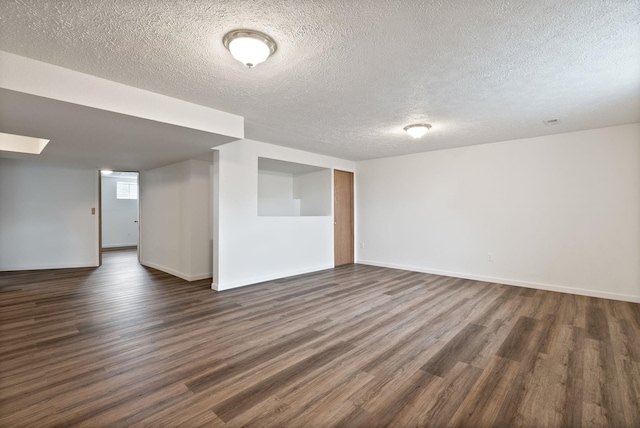 609 E Wild Rose Rd, Colbert, WA 99005 - empty room featuring dark wood finished floors, a textured ceiling, and baseboards