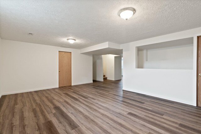 609 E Wild Rose Rd, Colbert, WA 99005 - spare room with wood finished floors, a textured ceiling, and baseboards