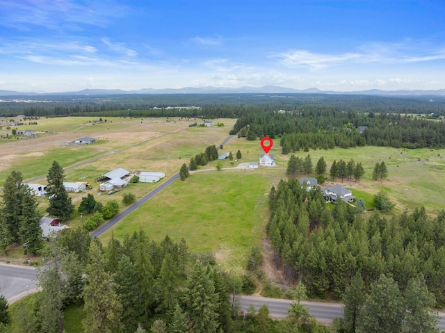 609 E Wild Rose Rd, Colbert, WA 99005 - aerial view of property's location with a mountainous background, a forest, and rural landscape
