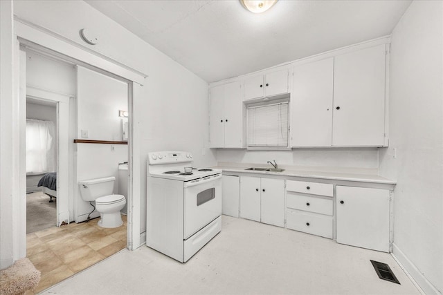 2304 E Dalke Ave, Spokane, WA 99207 - kitchen featuring white range with electric cooktop, a sink, light countertops, white cabinetry, and light floors