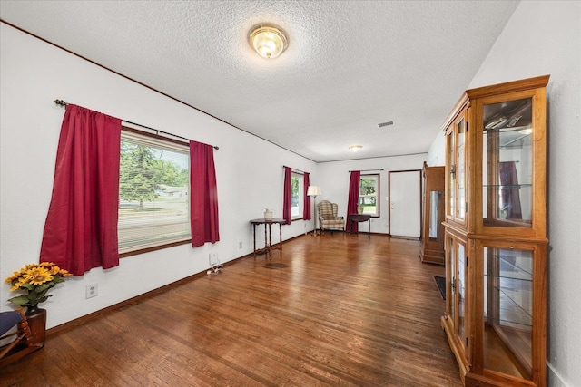 2304 E Dalke Ave, Spokane, WA 99207 - spare room featuring wood finished floors, a textured ceiling, and baseboards