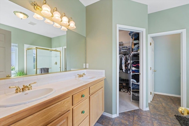 7920 S Parway Ln, Cheney, WA 99004 - full bathroom with a spacious closet, a stall shower, double vanity, and baseboards