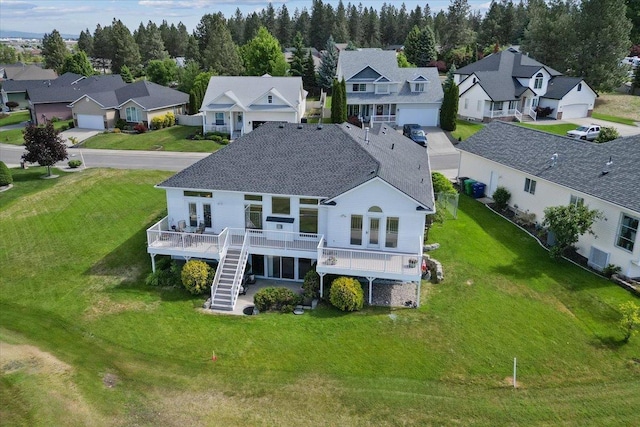 7920 S Parway Ln, Cheney, WA 99004 - rear view of house featuring a residential view, stairway, a wooden deck, roof with shingles, and a lawn