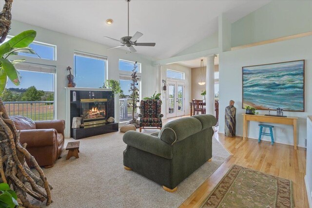 7920 S Parway Ln, Cheney, WA 99004 - living area with a glass covered fireplace, a ceiling fan, healthy amount of natural light, high vaulted ceiling, and wood finished floors
