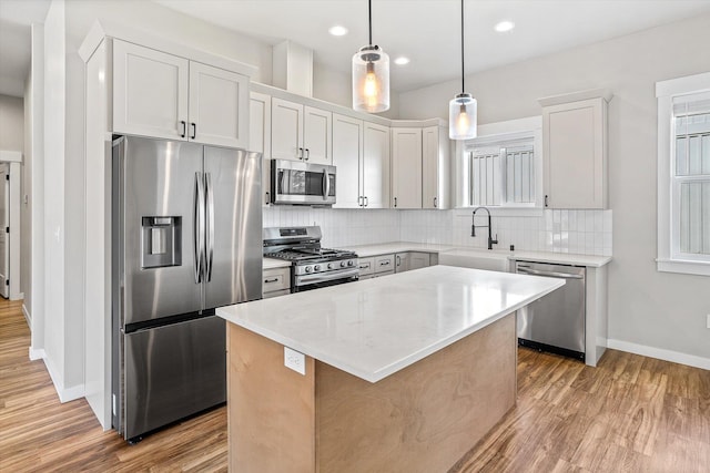40083 Lake Terrace Ct, Loon Lake, WA 99148 - kitchen with appliances with stainless steel finishes, a sink, baseboards, wood finished floors, and recessed lighting