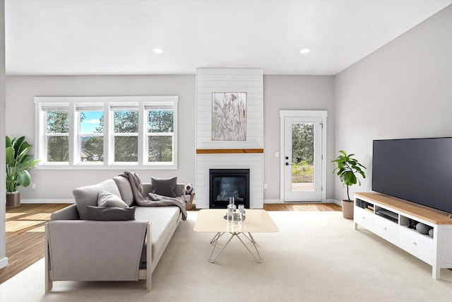 40083 Lake Terrace Ct, Loon Lake, WA 99148 - living area featuring wood finished floors, baseboards, a fireplace, and recessed lighting