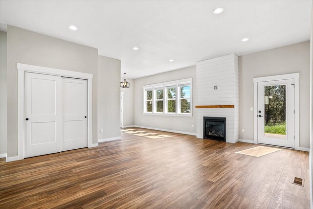 40083 Lake Terrace Ct, Loon Lake, WA 99148 - unfurnished living room featuring wood finished floors, a fireplace, baseboards, and recessed lighting