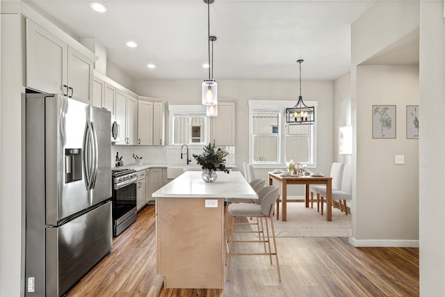 40083 Lake Terrace Ct, Loon Lake, WA 99148 - kitchen featuring stainless steel appliances, a sink, tasteful backsplash, light wood-style flooring, and recessed lighting