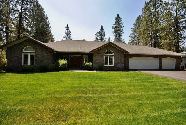 3704 E Pineland Rd, Colbert, WA 99005 - single story home with an attached garage, asphalt driveway, brick siding, and a front yard