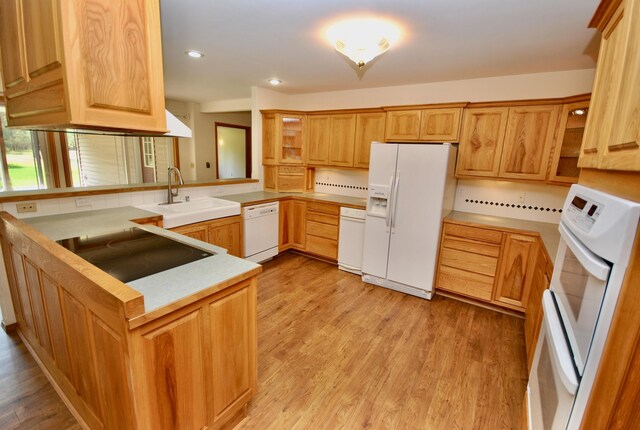 3704 E Pineland Rd, Colbert, WA 99005 - kitchen featuring white appliances, a sink, open shelves, a peninsula, and light wood-style floors