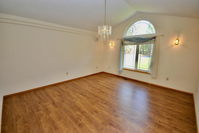 3704 E Pineland Rd, Colbert, WA 99005 - unfurnished room featuring wood finished floors, vaulted ceiling, a chandelier, and baseboards