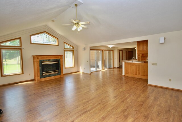 3704 E Pineland Rd, Colbert, WA 99005 - unfurnished living room with ceiling fan, vaulted ceiling, a premium fireplace, healthy amount of natural light, and light wood finished floors