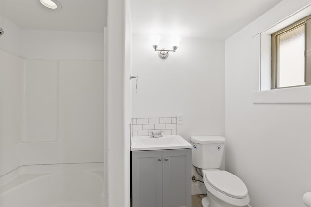13812 E Rockwell Ave, Spokane, WA 99216 - full bath with toilet, vanity, a shower, and decorative backsplash