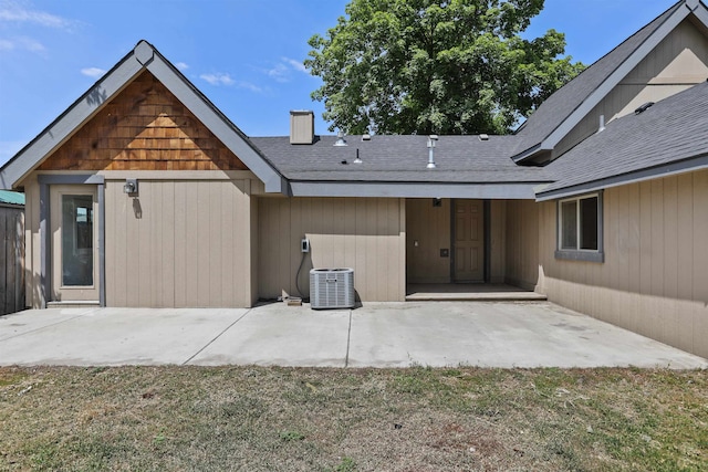 13812 E Rockwell Ave, Spokane, WA 99216 - rear view of property with a patio, a chimney, roof with shingles, and central AC