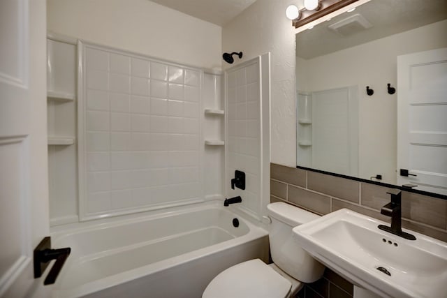 5320 N Ash St, Spokane, WA 99205 - bathroom featuring toilet, bathtub / shower combination, a sink, and tile walls