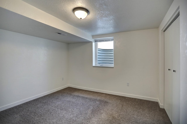 5320 N Ash St, Spokane, WA 99205 - unfurnished bedroom featuring a textured ceiling, dark carpet, a closet, and baseboards