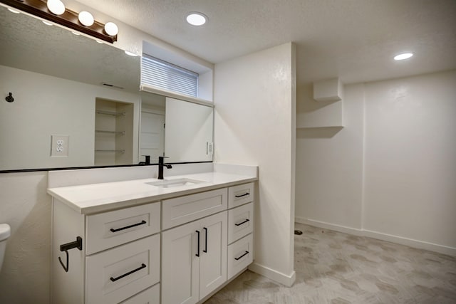 5320 N Ash St, Spokane, WA 99205 - bathroom with vanity, recessed lighting, baseboards, toilet, and a textured ceiling