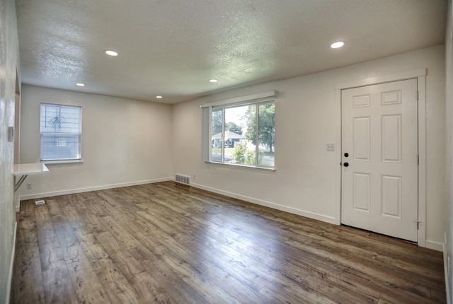 5320 N Ash St, Spokane, WA 99205 - unfurnished living room featuring wood-type flooring, recessed lighting, baseboards, and a textured ceiling