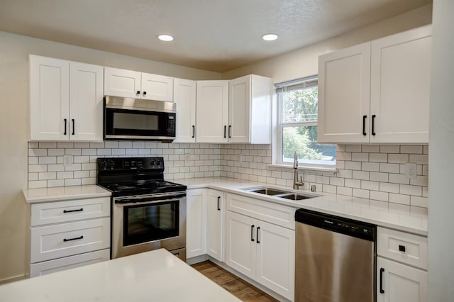 5320 N Ash St, Spokane, WA 99205 - kitchen featuring stainless steel appliances, a sink, light countertops, white cabinetry, and recessed lighting