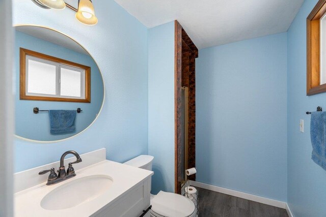 4615 E Russell Rd, Colbert, WA 99005 - full bathroom featuring toilet, wood finished floors, vanity, and a shower