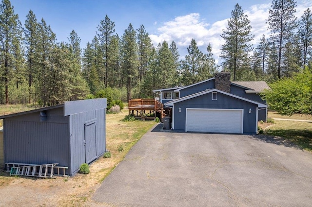 4615 E Russell Rd, Colbert, WA 99005 - view of front of home with driveway, a deck, a chimney, and a garage