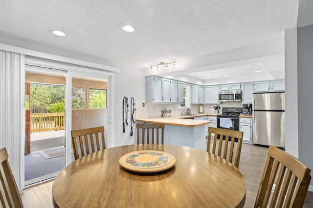 4615 E Russell Rd, Colbert, WA 99005 - dining space featuring light wood-style flooring, a textured ceiling, and recessed lighting