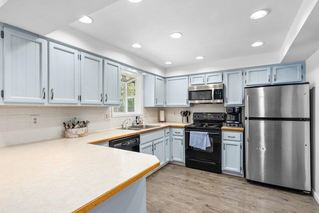 4615 E Russell Rd, Colbert, WA 99005 - kitchen with black appliances, light countertops, a sink, light wood-style floors, and recessed lighting