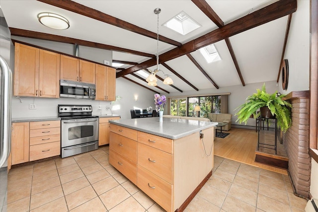 2111 E 34th Ave, Spokane, WA 99203 - kitchen featuring stainless steel appliances, light brown cabinets, a skylight, light tile patterned floors, and a kitchen island