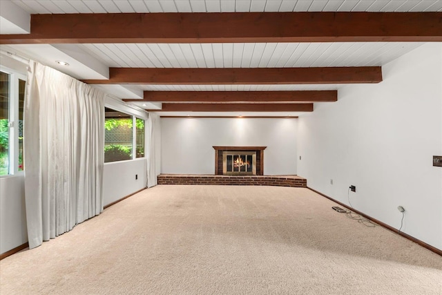 2111 E 34th Ave, Spokane, WA 99203 - unfurnished living room featuring carpet floors, a brick fireplace, baseboards, and wooden ceiling with exposed beams