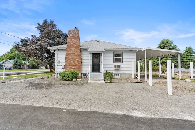 12117 E Boone Ave, Spokane Valley, WA 99206 - view of front facade featuring a chimney, driveway, a carport, and a shingled roof