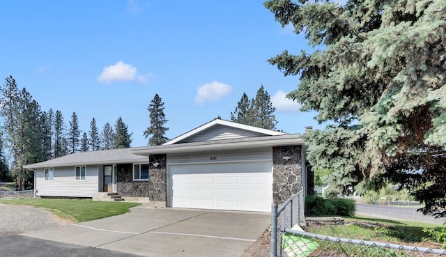 11619 N Roundup Rd, Mead, WA 99021 - ranch-style house with stone siding, concrete driveway, an attached garage, and entry steps