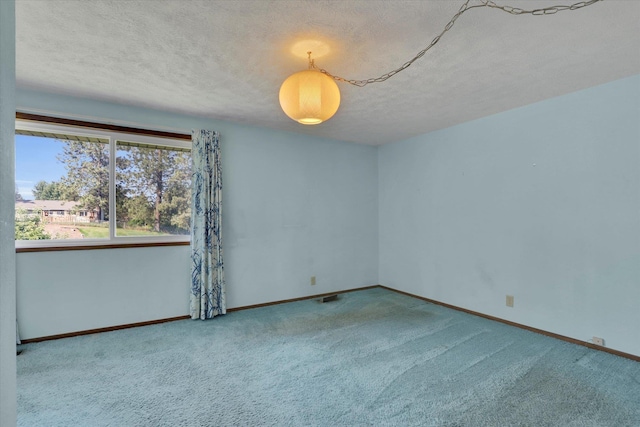 11619 N Roundup Rd, Mead, WA 99021 - carpeted empty room with a textured ceiling and baseboards