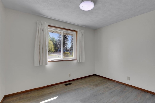 11619 N Roundup Rd, Mead, WA 99021 - spare room featuring wood finished floors and baseboards
