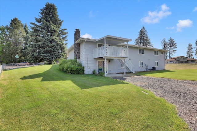 11619 N Roundup Rd, Mead, WA 99021 - rear view of property with a chimney, a lawn, a wooden deck, cooling unit, and stairs