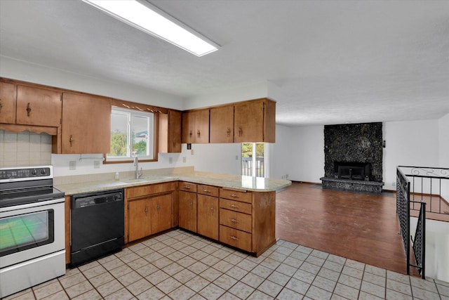 11619 N Roundup Rd, Mead, WA 99021 - kitchen featuring black dishwasher, stainless steel electric range oven, light countertops, a peninsula, and a sink