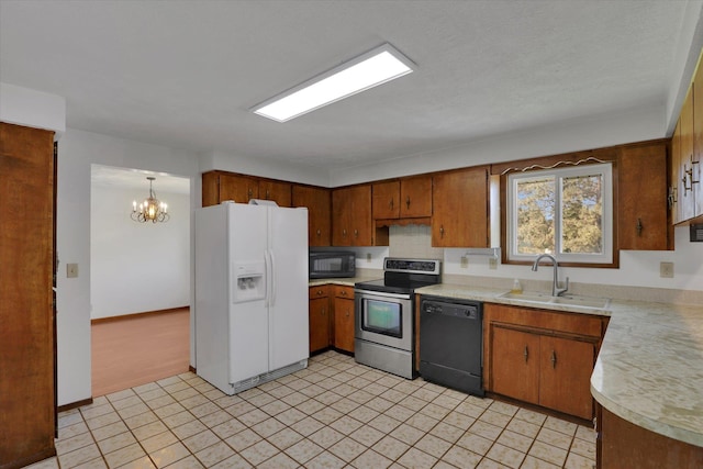 11619 N Roundup Rd, Mead, WA 99021 - kitchen with black appliances, a sink, light countertops, a chandelier, and brown cabinets