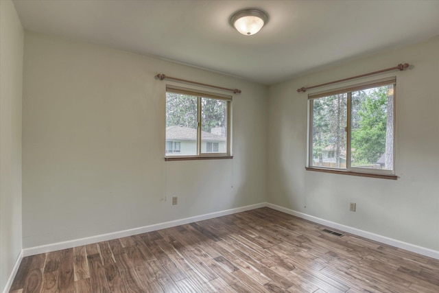 1815 E 64th Ave, Spokane, WA 99223 - unfurnished room with wood finished floors and baseboards