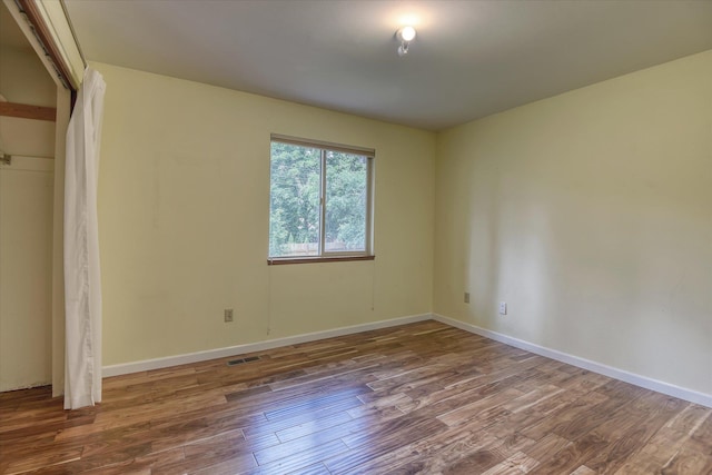 1815 E 64th Ave, Spokane, WA 99223 - unfurnished bedroom with wood finished floors, baseboards, and a closet