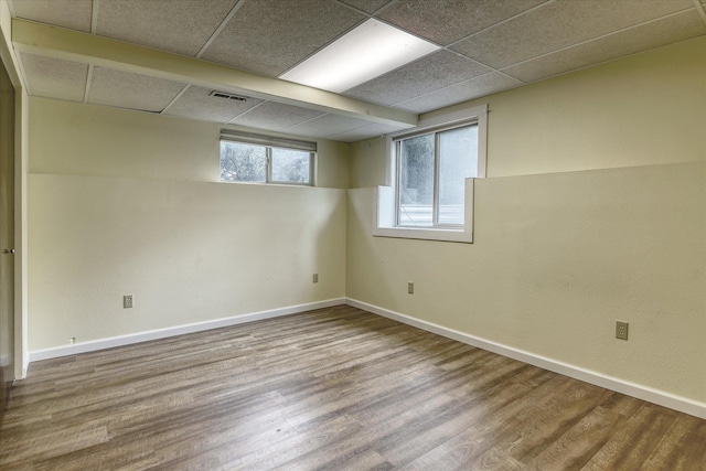 1815 E 64th Ave, Spokane, WA 99223 - below grade area featuring wood finished floors, a paneled ceiling, and baseboards