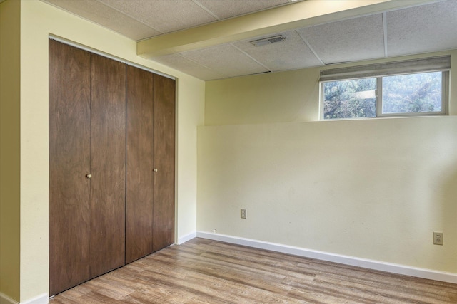 1815 E 64th Ave, Spokane, WA 99223 - unfurnished bedroom featuring a closet, light wood-style flooring, baseboards, and a paneled ceiling