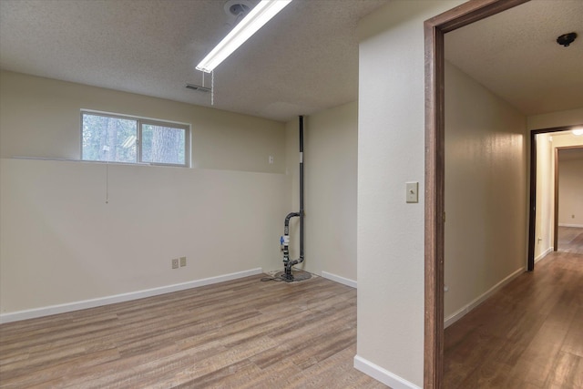 1815 E 64th Ave, Spokane, WA 99223 - below grade area with wood finished floors, baseboards, and a textured ceiling