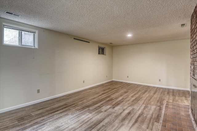 1815 E 64th Ave, Spokane, WA 99223 - basement with wood finished floors, a textured ceiling, baseboards, and recessed lighting