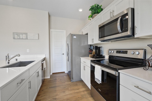 8113 S Safflower St, Cheney, WA 99004 - kitchen featuring appliances with stainless steel finishes, a sink, white cabinets, light countertops, and recessed lighting