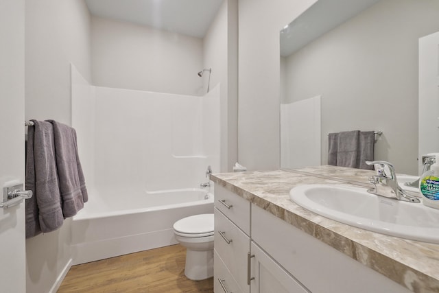 8113 S Safflower St, Cheney, WA 99004 - bathroom with vanity, toilet, wood finished floors, and shower / bathtub combination